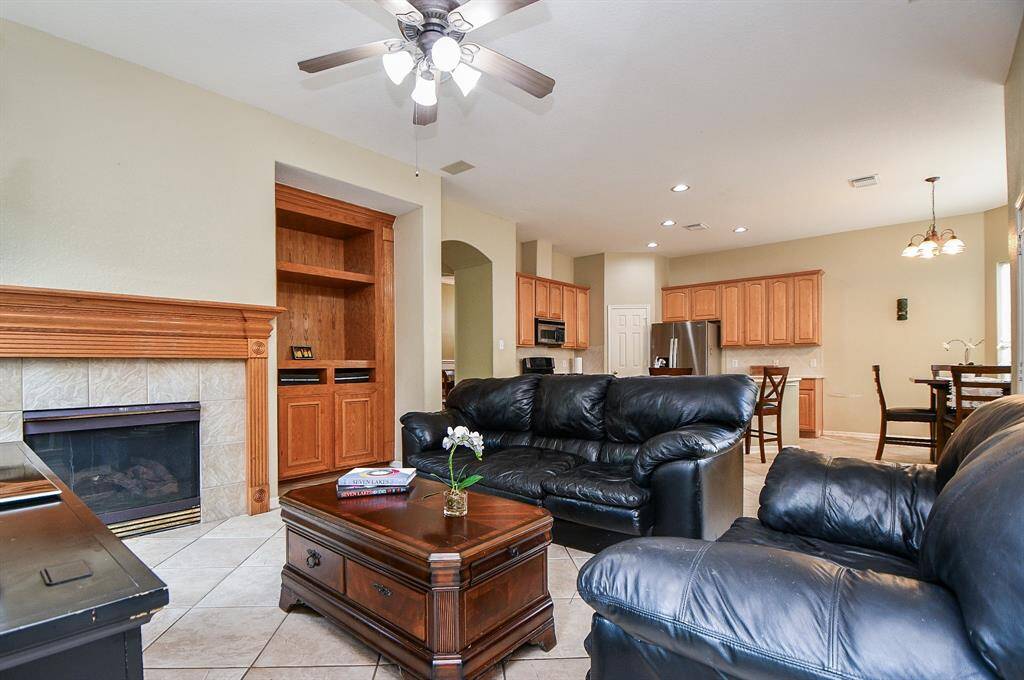 Even in a generous space of this size, you can create a cozy vibe with furnishings of just about every and any size and shape. Note the built-in shelving unit, and the star of the show, the gas connected fireplace.