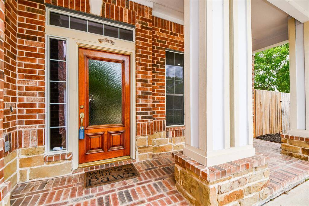 The regal, brick lined covered front entrance hosts attractive columns and cozy space for seasonal seating and/or favorite garden displays. Shake out your welcome mat!