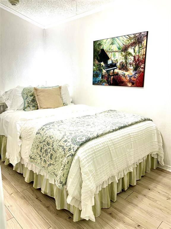 The bedroom is at the front of the condo and has new paint, flooring and bedding. There is a flatscreen tv on the wall next to the bed!