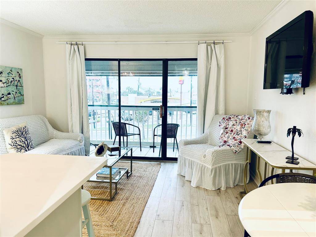 Spacious living space with flatscreen tv, sofa bed and view of the Galveston Bay