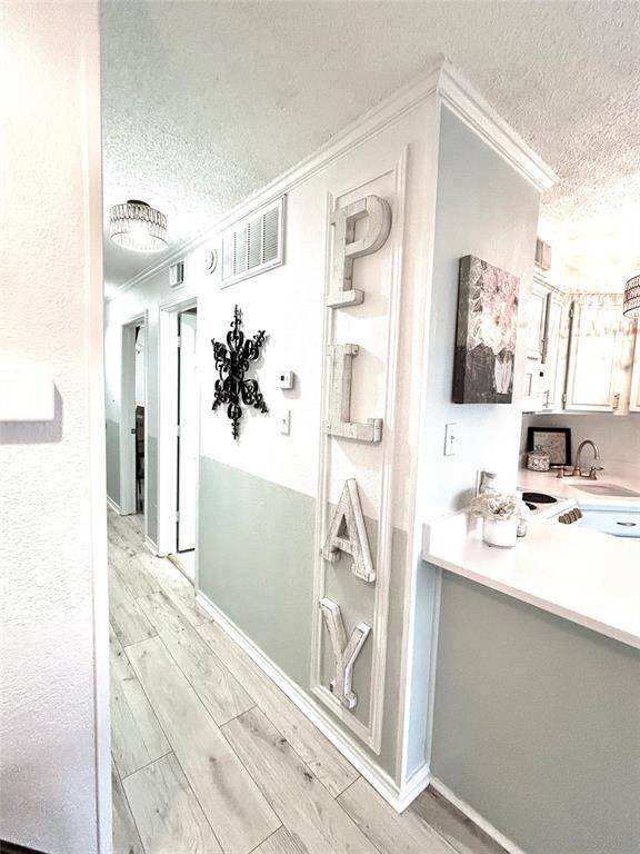 The hallway leading to the front door, bedroom, bath and built in bunk beds!