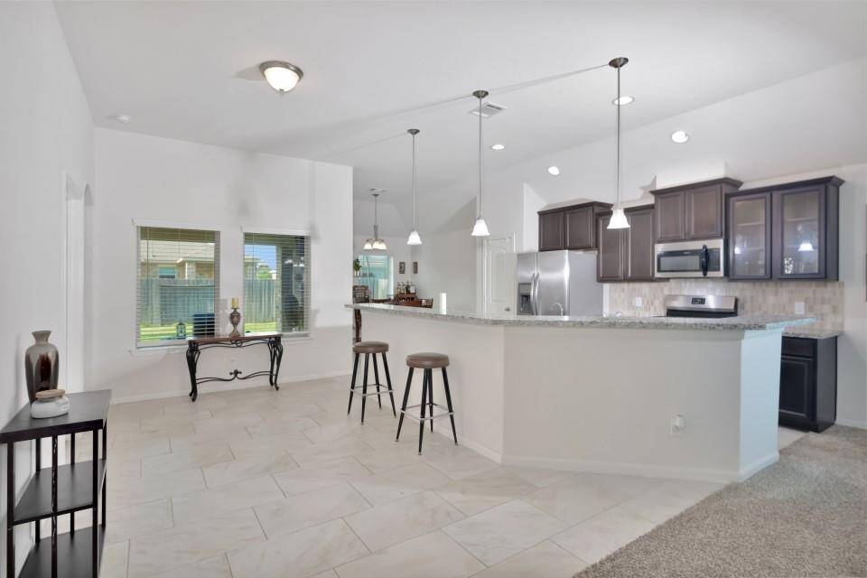 View of the kitchen, plenty of space for seating at the bar-height island.