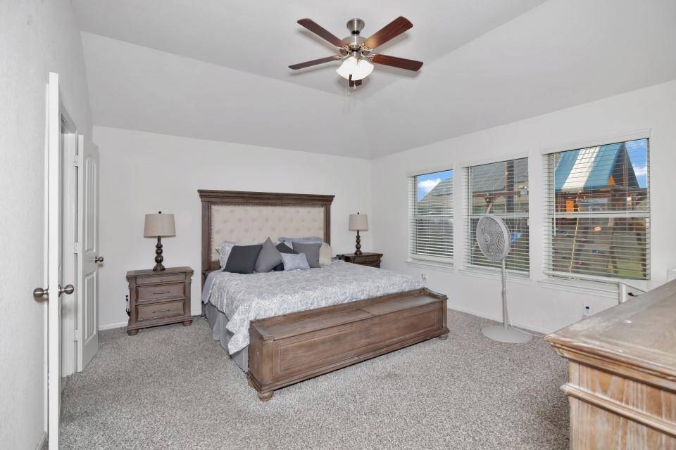 Spacious primary bedroom features high ceilings, plenty of natural light and an on suite bathroom.