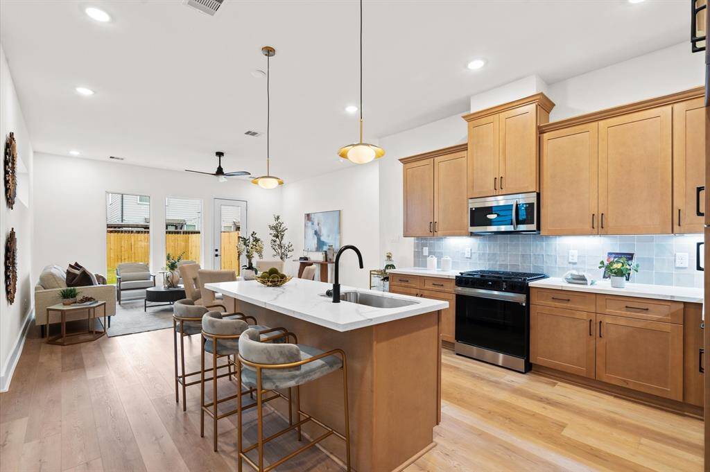 Spacious kitchen with a generous island and quartz countertops.*Photos from a previous home by the same developer, selections and floor plans may vary*