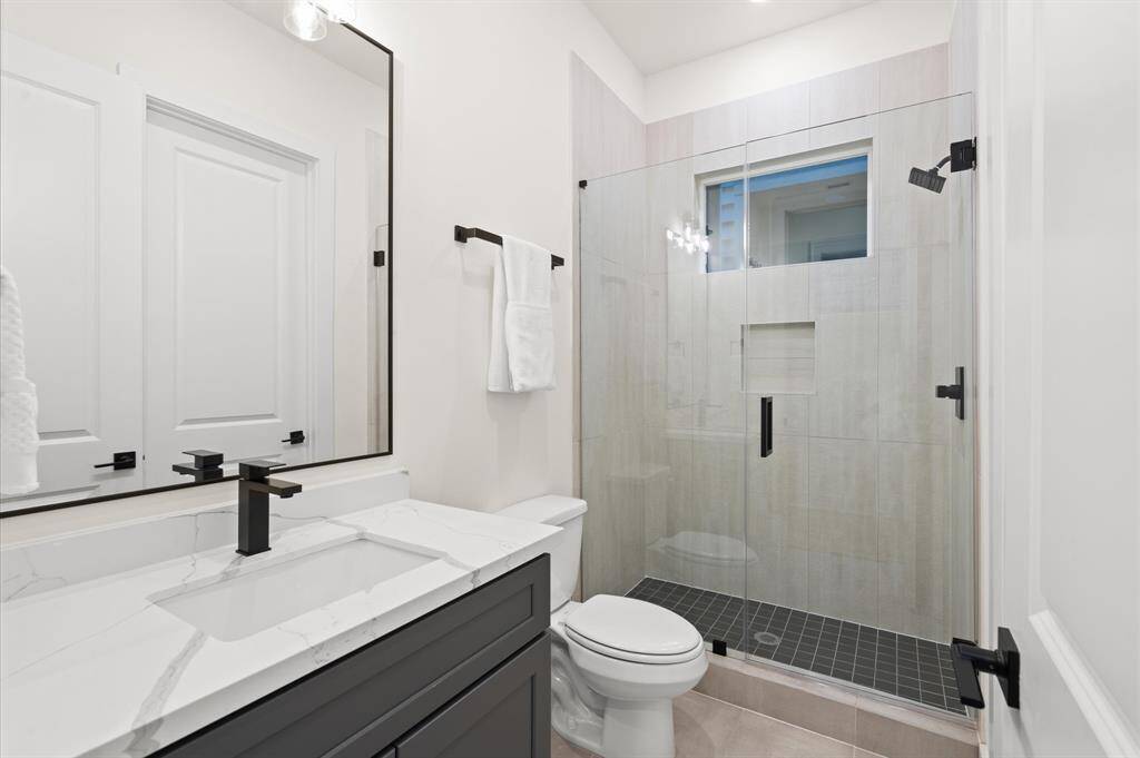 First floor guest suite has a full bathroom with walk-in shower.*Photos from a previous home by the same developer, selections and floor plans may vary*