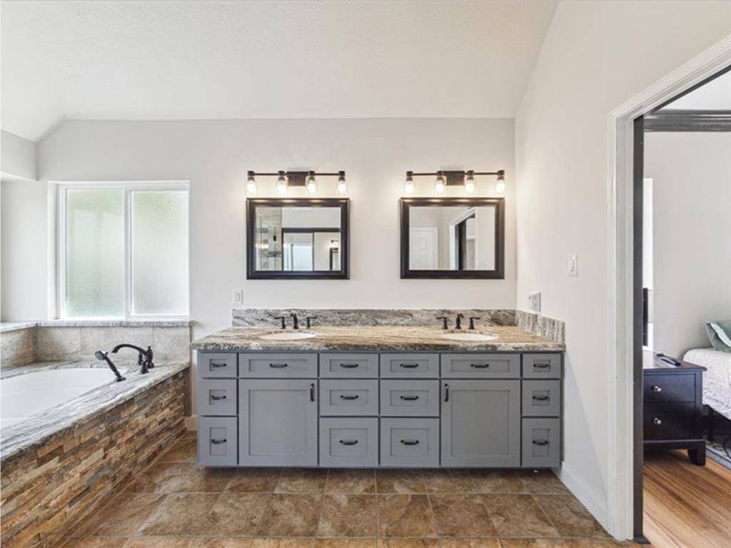 A CLOSER LOOK AT THE DOUBLE VANITY SHOWCASES ALL-NEW CABINETS, COUNTERTOPS, AND FIXTURES. NEW HOT WATER HEATER, OFFERS MODERN COMFORT IN EVERY DETAIL.