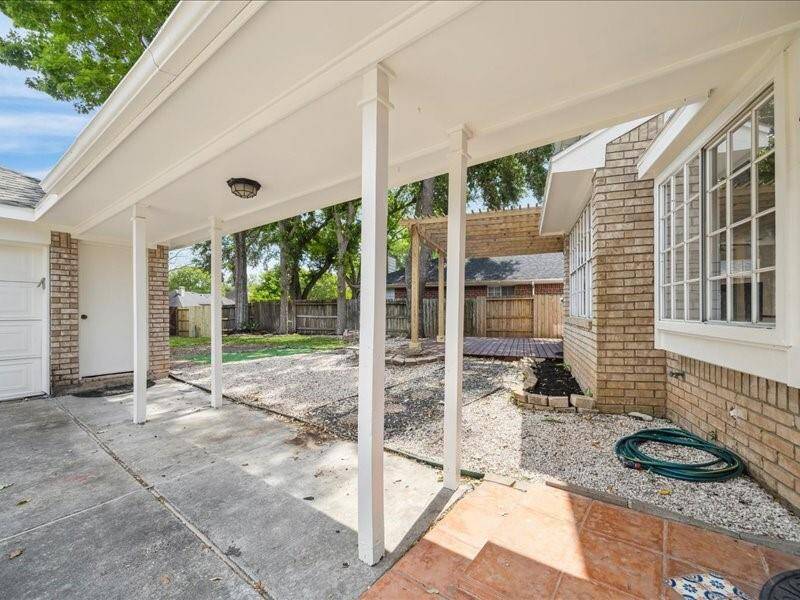 ENJOY SHADED OUTDOOR SPACE UNDER THE EXTENDED BREEZEWAY THAT CONNECTS THE HOME TO THE DETACHED GARAGE.