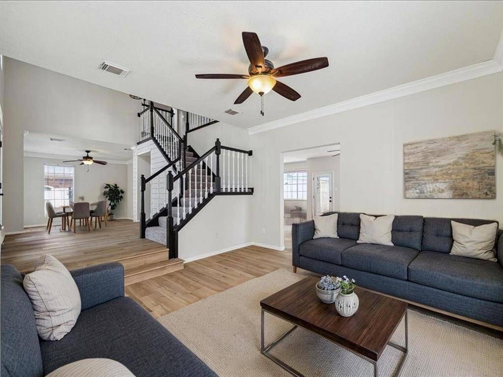 OPEN STAIRCASE DESIGN ADDS ARCHITECTURAL INTEREST AND CONNECTS TO MULTIPLE LIVING SPACES. BRAND NEW FLOORING ALTHROUGHOUT.