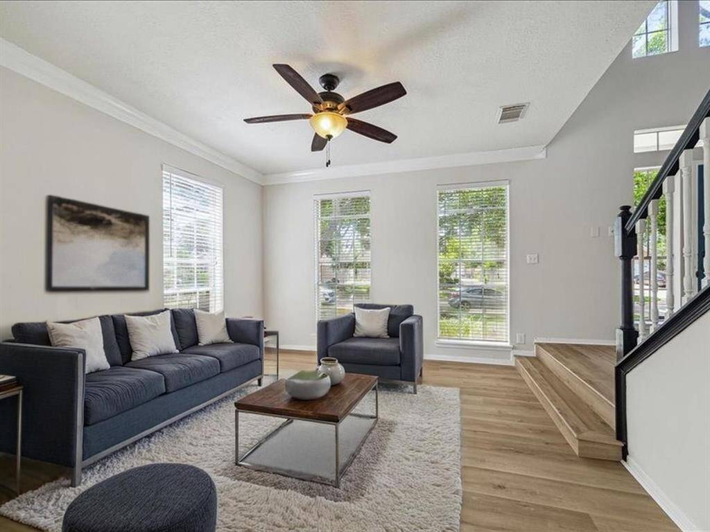 BRIGHT AND AIRY FORMAL LIVING ROOM WITH TALL WINDOWS OVERLOOKING THE FRONT YARD. **This room has been virtually staged.