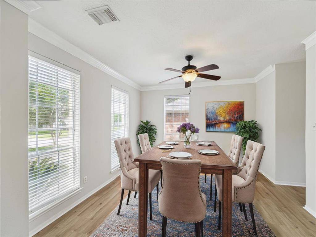 ELEGANT DINING ROOM FILLED WITH NATURAL LIGHT, FEATURING NEW LUXURY VINYL FLOORING AND FRESH INTERIOR PAINT. **This room has been virtually staged.