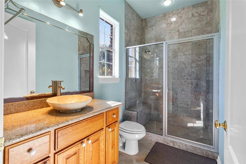 Elegant downstairs bedroom featuring ample natural light, tasteful tile flooring, and an adjoining cozy study nook.
