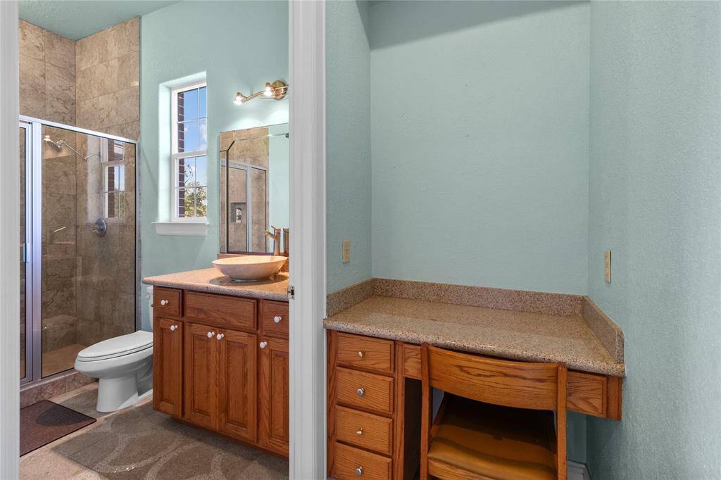 Spacious downstairs bedroom with natural light and elegant tile flooring.
