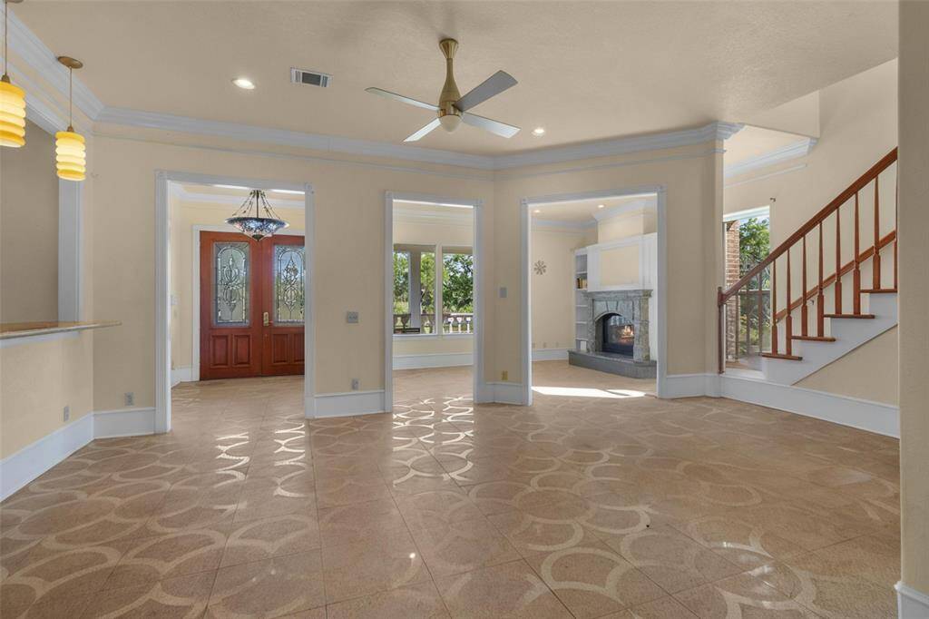 Elegant downstairs bathroom featuring a modern glass shower, stylish vessel sink, and abundant natural light.