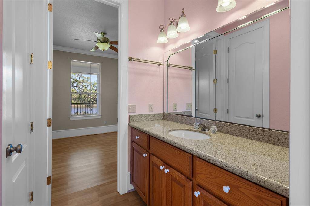 Bright and inviting upstairs bedroom with large windows offering scenic views and ample natural light.