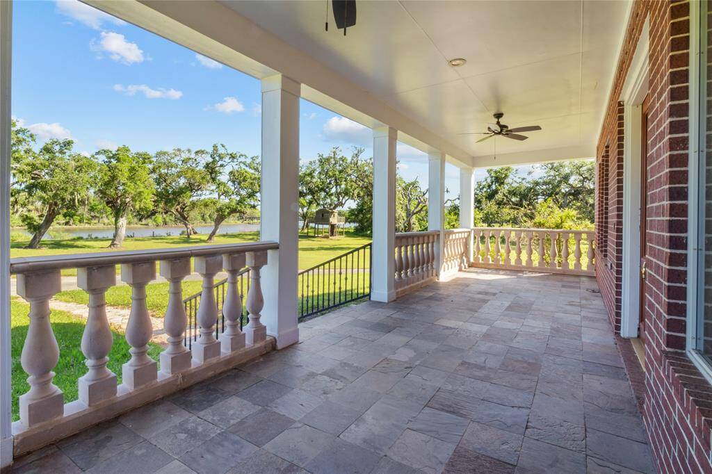 Spacious balcony offering serene views of lush greenery, perfect for relaxation and entertaining.