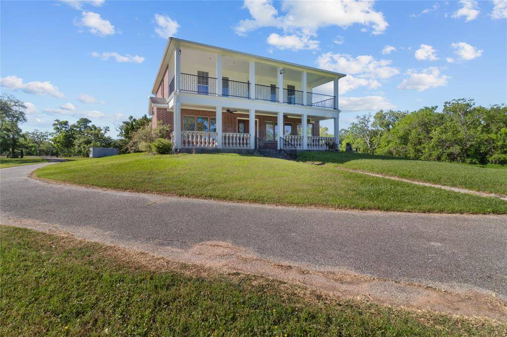 Enjoy serene riverside views from this elegant home, featuring expansive balconies and lush surroundings. Perfect for peaceful living.
