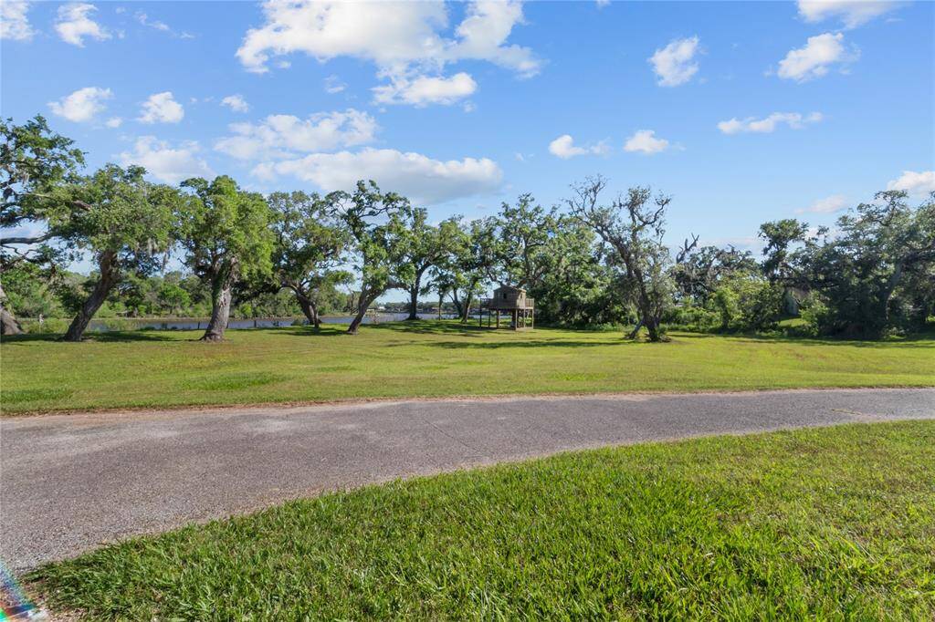 Breathtaking front view featuring lush greenery and serene water, offering a peaceful and scenic setting.