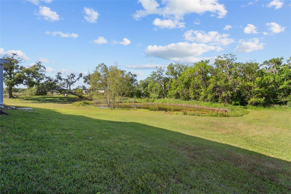 Tranquil pond nestled within lush greenery, offering a serene and picturesque backdrop for your dream home.