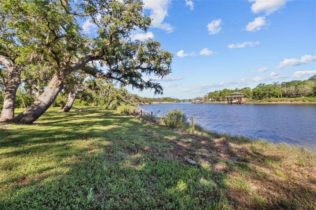 Enjoy serene riverside views and lush greenery from the right side of the yard—perfect for relaxation and outdoor activities.