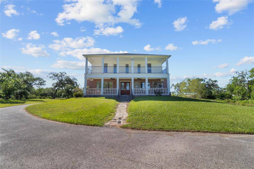 Enjoy serene riverside views from this beautiful home, surrounded by lush greenery and expansive open space.