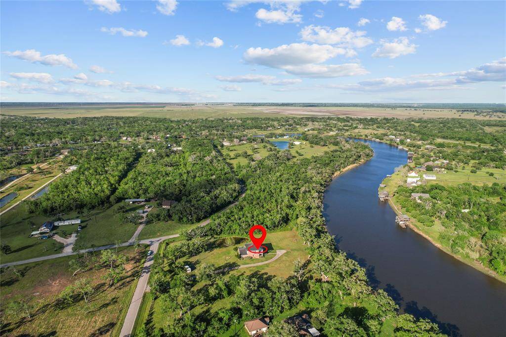 Breathtaking aerial view showcasing a lush riverside landscape, offering serene surroundings and a perfect blend of nature and tranquility. Ideal for those seeking a peaceful retreat.