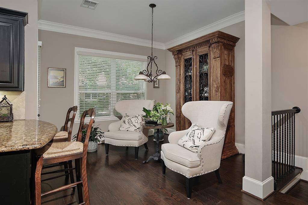 Casual dining nook off kitchen has a large window with tree-top views and natural light, perfect for intimate gatherings or a relaxing morning coffee.