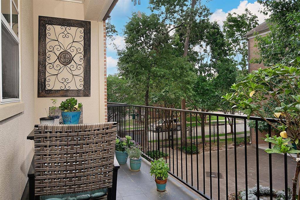 This balcony is a great outdoor spot to enjoy a beverage and nature.