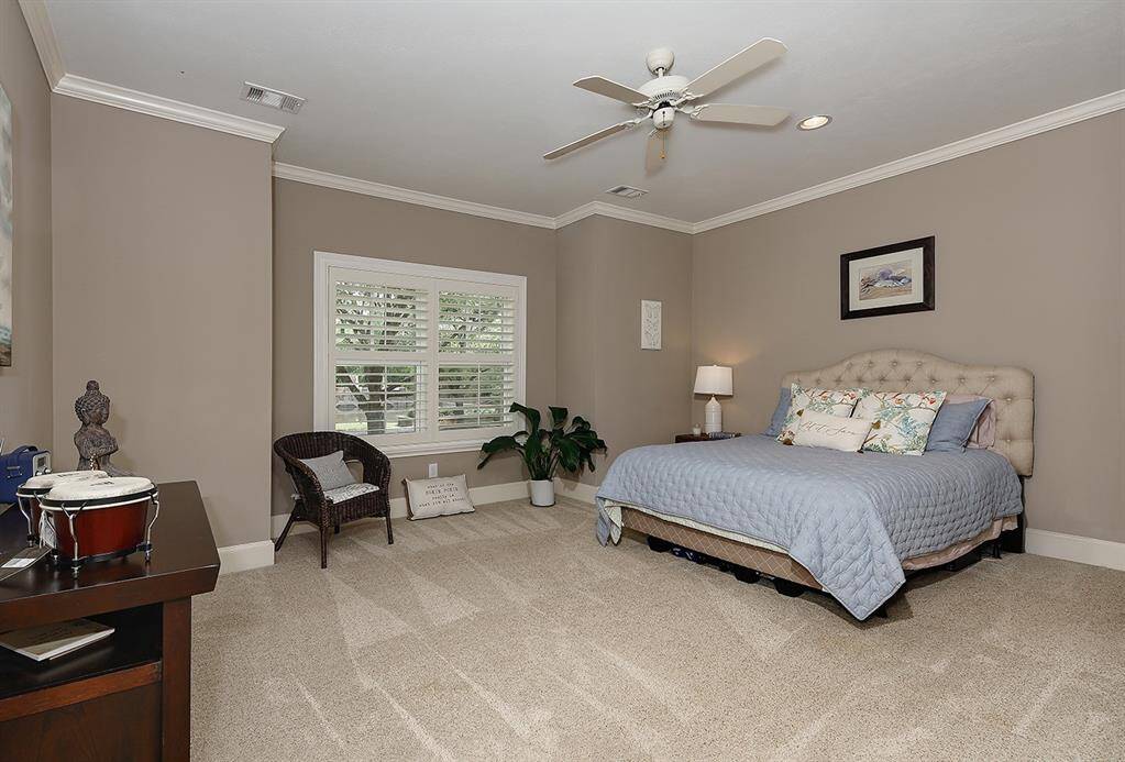 First floor guest bedroom has plenty of space and a great reading spot window setting overlooking trees.