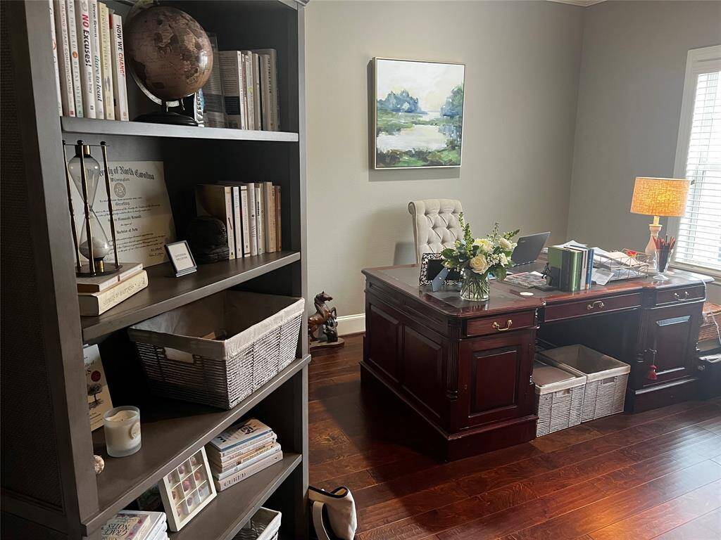 Home office with plenty of space for productivity and focus. Hardwood floors are a nice feature.