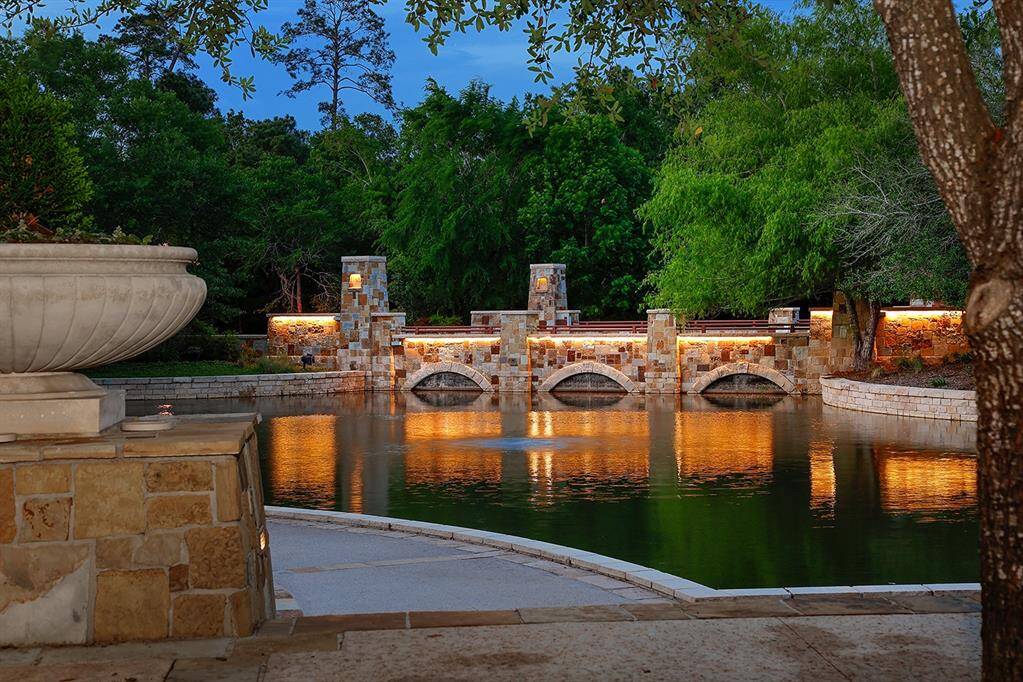 Pristine landscaping, stone accented gardens, paths and bridges well-lit throughout community.