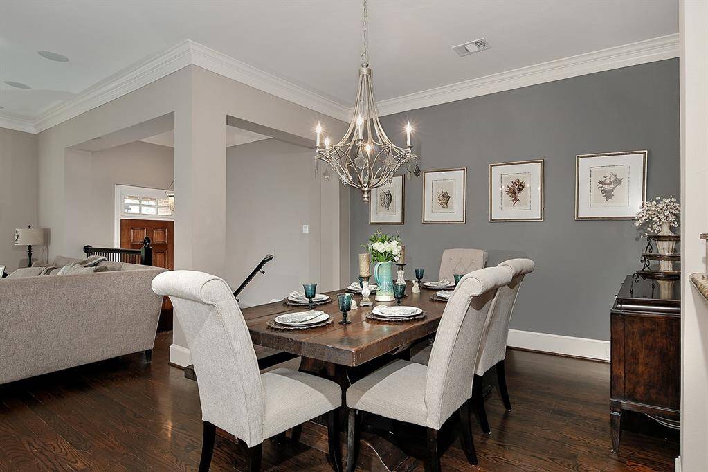 Elegant dining area perfect for entertaining, featuring a chic chandelier and stylish decor.