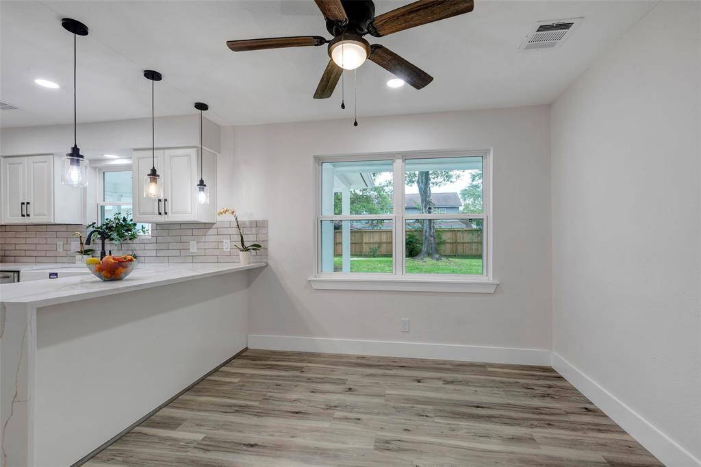 Breakfast area with natural light and ceiling fan and Vinyl flooring.