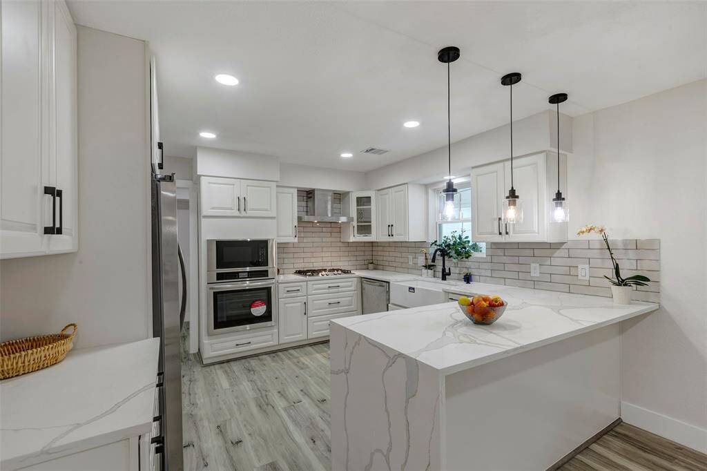 Chef's dream kitchen with new appliances, Quartz countertops, light fixtures and cabinets.