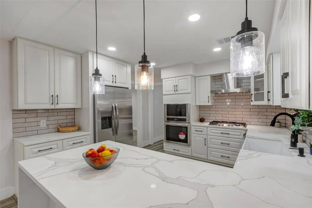 Completely newly remodeled kitchen with new appliances, Quartz countertops, light fixtures and cabinets.
