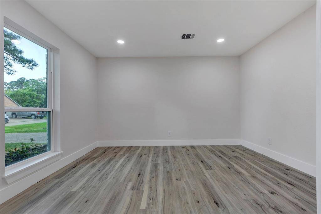 Formal dining room with recessed lights and new Vinyl flooring.