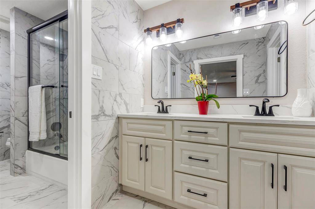 Stunning primary bathroom with double sink, shower and tub comb.