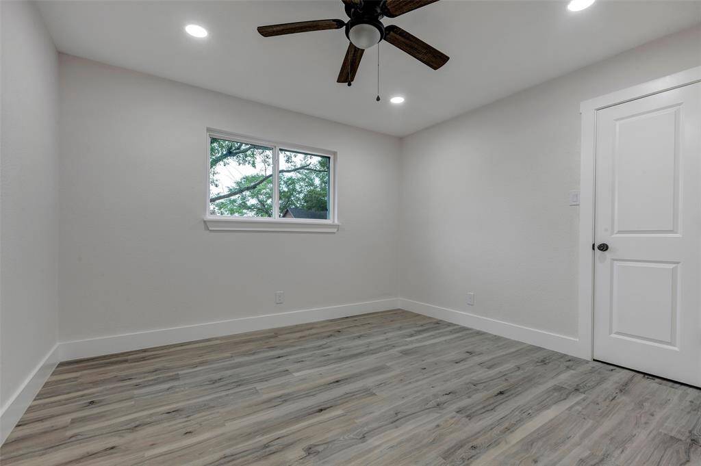 Secondary bedroom #2 with walk in closet, Vinyl flooring, ceiling fan and recess light.