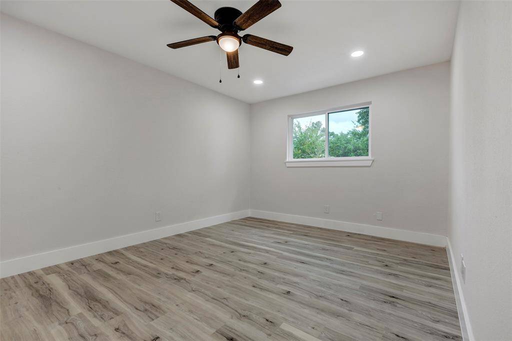 Secondary bedroom #3 with walk in closet, Vinyl flooring, ceiling fan and recess light.