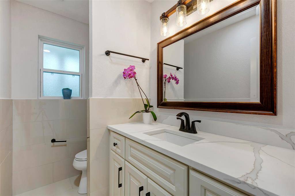 Newly remodeled Power room is conveniently located downstairs. New Quartz countertops, toilet and finishes.