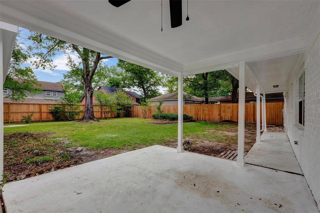 Large covered patio with ceiling fan.