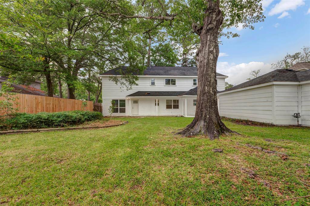 Enormous back yard with mature trees and oversized garage.