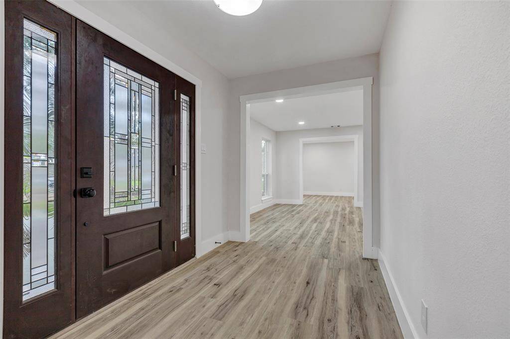 Grand entrance with brand new wide glass door and Vinyl flooring and fresh paint!
