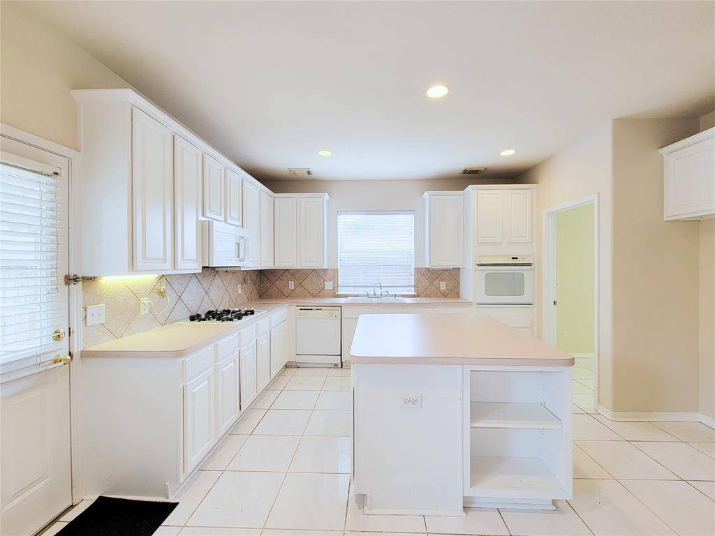 Huge Kitchen with white cabinets & island.