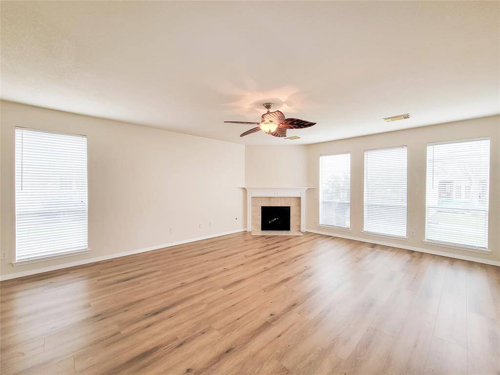 Spacious Family room with corner fireplace.