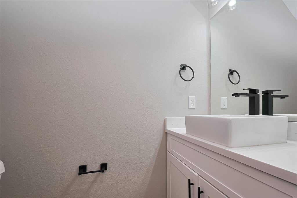 Sleek & Modern Powder RoomThis guest bath makes a bold statement with a contemporary square vessel sink, matte black fixtures, and crisp white shaker cabinetry. Clean lines and minimalist design give this space a sophisticated, elevated feel—perfect for both functionality and style.