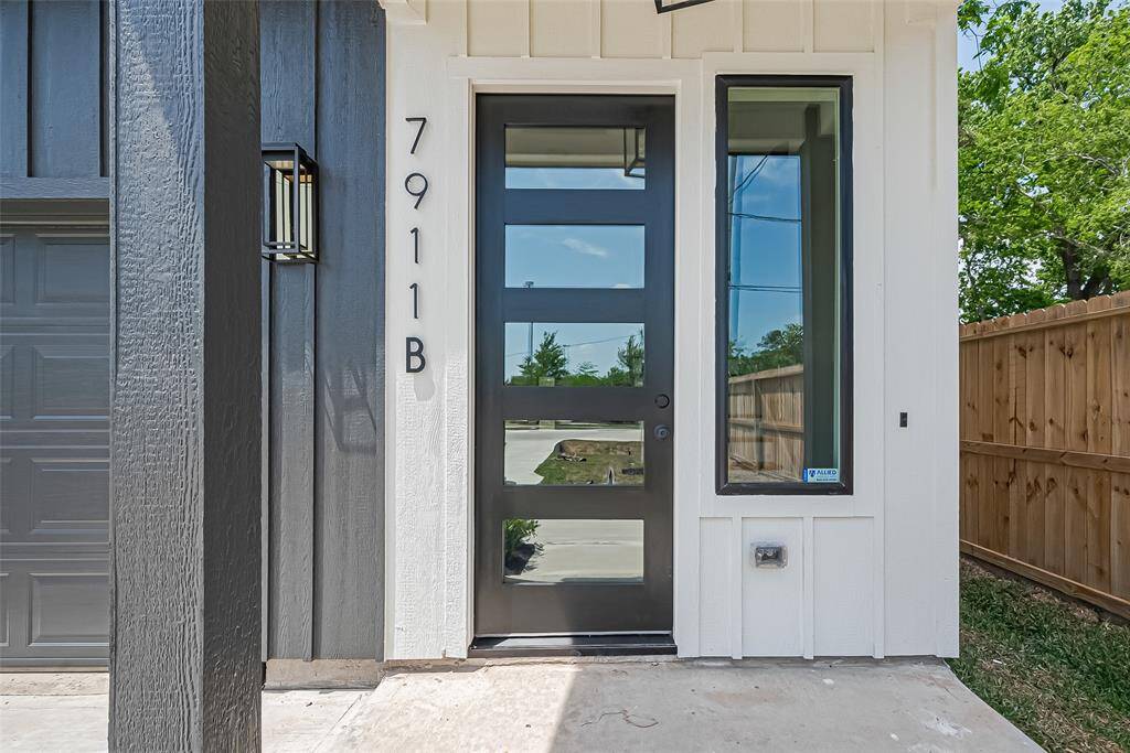 Private Entry with a Striking First ImpressionStep into 7911B through this bold modern doorway framed by black and white contrast, glass paneling, and a sleek vertical window. Clean architectural lines and a covered entryway provide both style and functionality—setting the tone for the upscale design that continues inside.