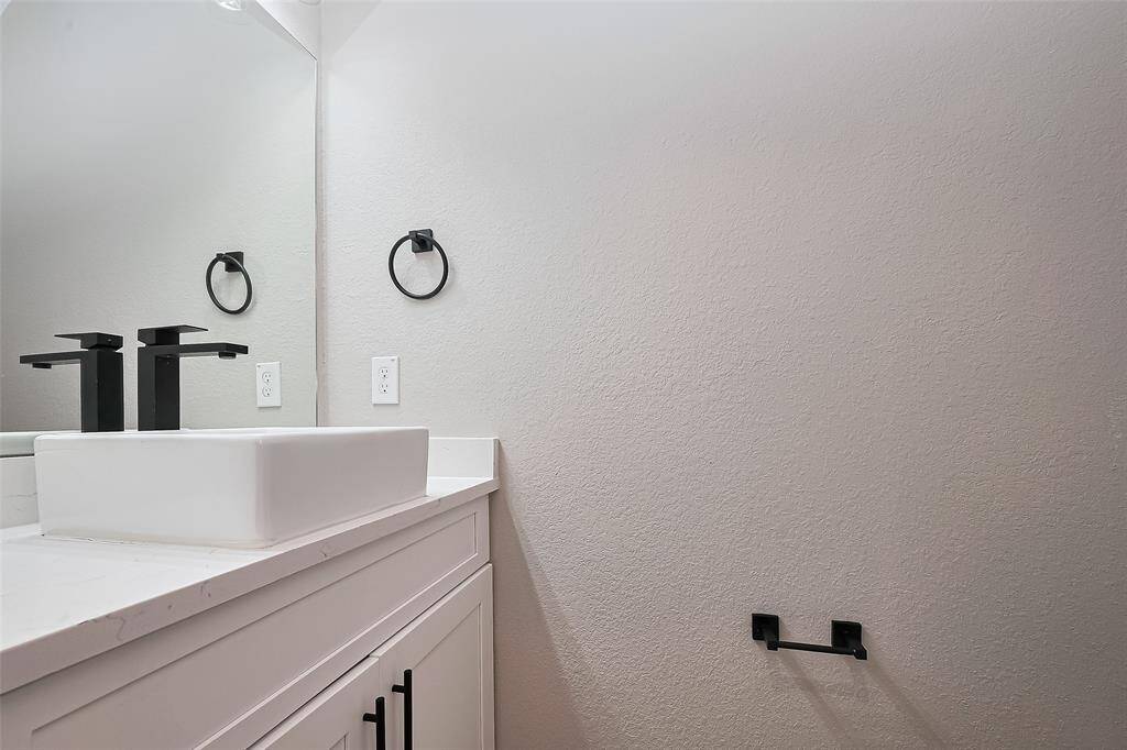 Modern Half-Bath with Bold FinishesThis chic powder room features a contemporary square vessel sink, quartz countertop, and matte black hardware for a sleek, polished look. Perfect for guests, the minimalist design delivers function and flair without compromising on style.