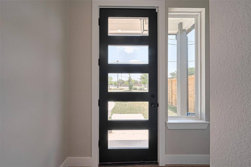 Bright & Welcoming Foyer with Modern LinesStep inside and instantly feel the natural light pour through the horizontal glass panels of the designer front door. Paired with a vertical side window, this entryway creates a bright, airy first impression while showcasing the clean architectural lines that carry throughout the home.
