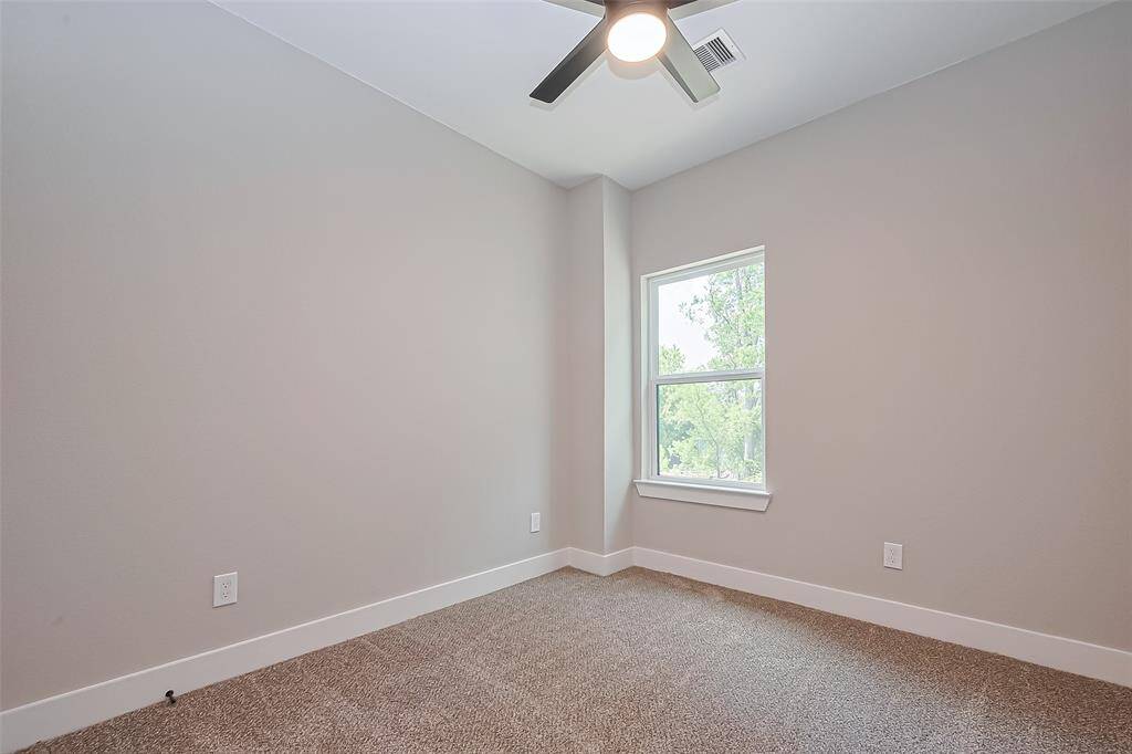 Sunlit Space with Peaceful ViewsThis upstairs bedroom offers serene views and plenty of natural light, creating a peaceful atmosphere ideal for rest, creativity, or productivity. Complete with neutral tones, plush carpeting, and a modern ceiling fan, it’s a flexible space ready for your lifestyle.