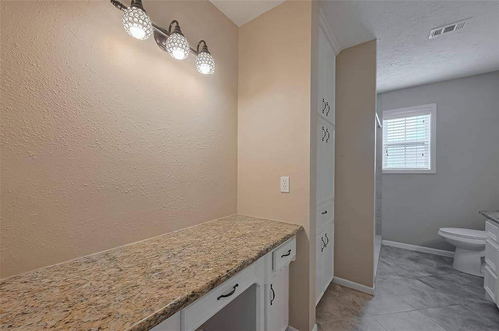 The primary bath has granite counters, lots of storage and a large shower.